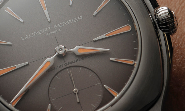 Dial closeup of Laurent Ferrier original sport tourbillon watch with gradient grey to purple dial and orange and white gold super luminova luminescent hand and indexes