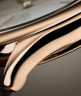 Focus picture on the lug of the warmly toned 18 750 5N red gold case of the new Classic Origin Beige LCF036.R5.BR5 Laurent Ferrier watch on a taupe background. photo by EastImage.