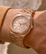 Wristshot of the Sport Auto 79 red gold watch with its cream-coloured dial.
