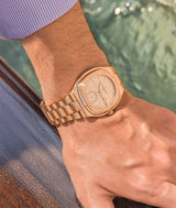 Wristshot of the Sport Auto 79 in red gold from a summer point of view, by the sea on a boat.