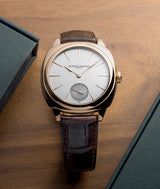 Lifestyle picture of the Square Micro-Rotor silver dial with a solid red gold case and brown alligator leather.