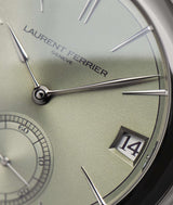 Macro view of the classic Laurent Ferrier minute assegai hand in white gold. The Magnetic Green dial is also pictured with its beautiful reflections.