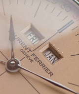close shot of laurent ferrier ecole micro rotor watch with yellow golden "vintage" dial's date windows