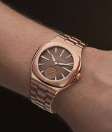 White man wearing the Tourbillon Grand Sport 'Golden Brown' with chocolate brown gradient opaline dial and integrated bracelet and case in a 5N red gold. Pictured by Cyril Biselx in Geneva