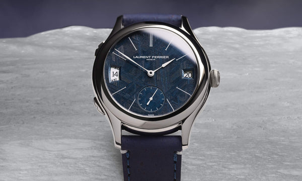 Laurent Ferrier fine dual-zone watch on the Classic case featuring an exclusive genuine météorite dial in deep navy blue. The watch is resting on what looks like the moon. Photo: Cyril Biselx 