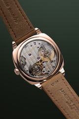 Lifestyle picture over the back case of the Square Micro-Rotor Evergreen with a view on the FBN229.01 calibre with a natural escapement.