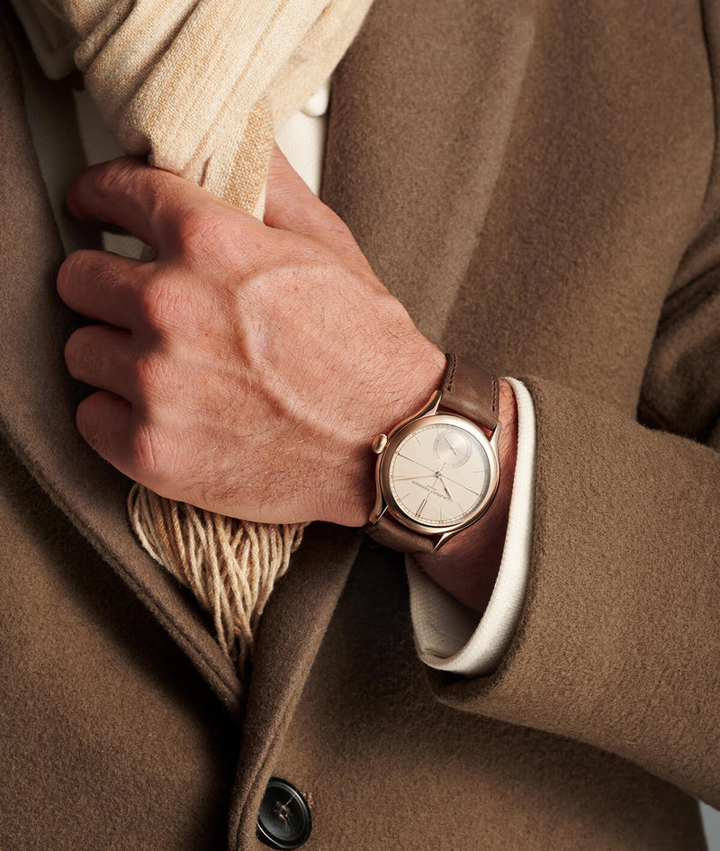 Hand wearing the new Classic Origin Beige with a brown coat and beige scarf