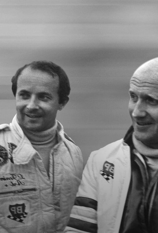 Portrait of Laurent Ferrier Fine Watchmaking brand founders during their participation of LeMans 24 hour race in 1979, France. The duo composed of Laurent Ferrier (left) and François Servanin (right) is against a motion blurred background.