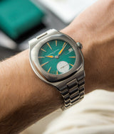 White man wearing the latest online exclusive LAURENT FERRIER Sport Auto 40 on his wrist. The watch has a beautiful green blue dial and features the number "40" on the second hand area.