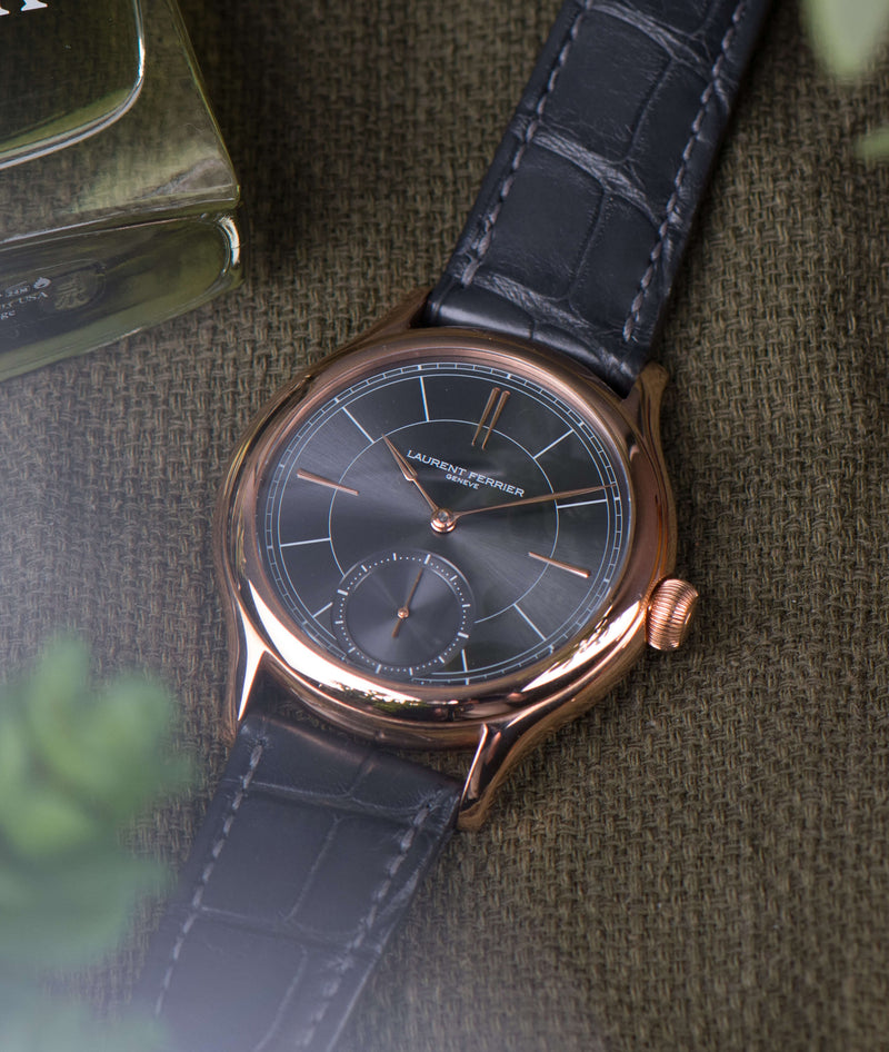 laurent ferrier classic micro-rotor in red-gold case assegai hands and indexes with grey sunburst dial with grey crocodile bracelet on green fabric