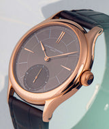 side angle view of laurent ferrier swiss independant watch manufacturer classic micro-rotor with grey sunburst dial and red-gold case and assegai hands and indexes