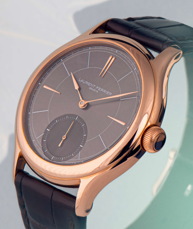 side angle view of laurent ferrier swiss independant watch manufacturer classic micro-rotor with grey sunburst dial and red-gold case and assegai hands and indexes
