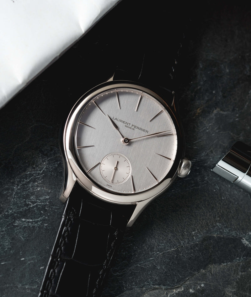 lifestyle of classic micro-rotor white-gold with vertical satin brushed dial and black crocodile bracelet on slate