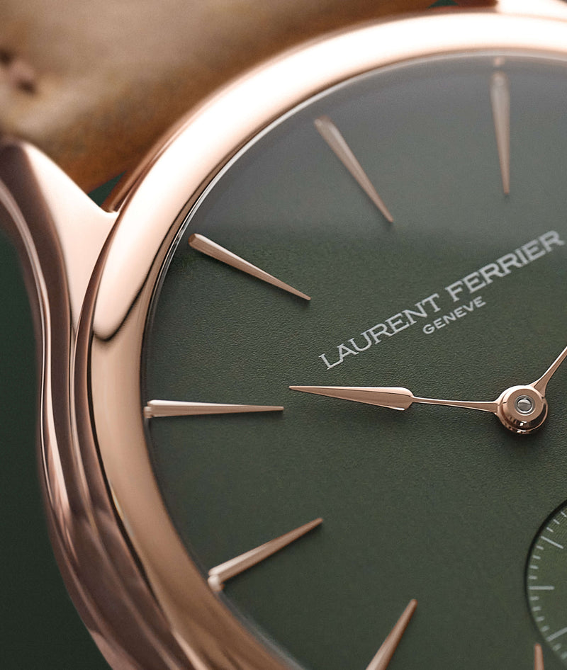 Macro view of rose gold indices and assegai hands and white LAURENT FERRIER logo on the 'Evergreen' forest green satiné dial on the Classic Micro-Rotor model.