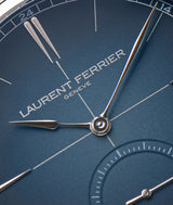 Macro close-up view of LF Genève's Classic Origin Blue gradient opaline dial featuring white gold "assegai" pressed hands and 12-hour indexes. The finish is slightly grainy in a soft way.