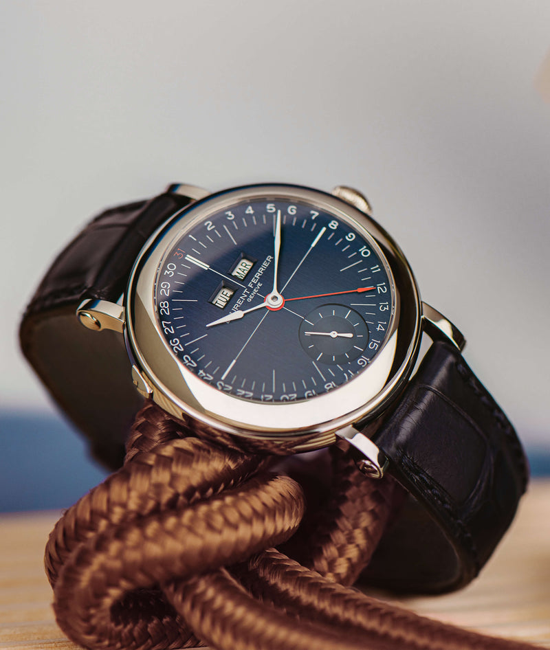 laurent ferrier blue ecole micro rotor watch in stainless steel case lying on a brown marine rope with a blue sky like background