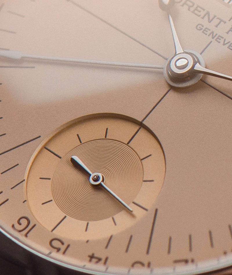 close macro shot of laurent ferrier yellow "vintage" dial on ecole micro rotor watch's snailed guilloché small second